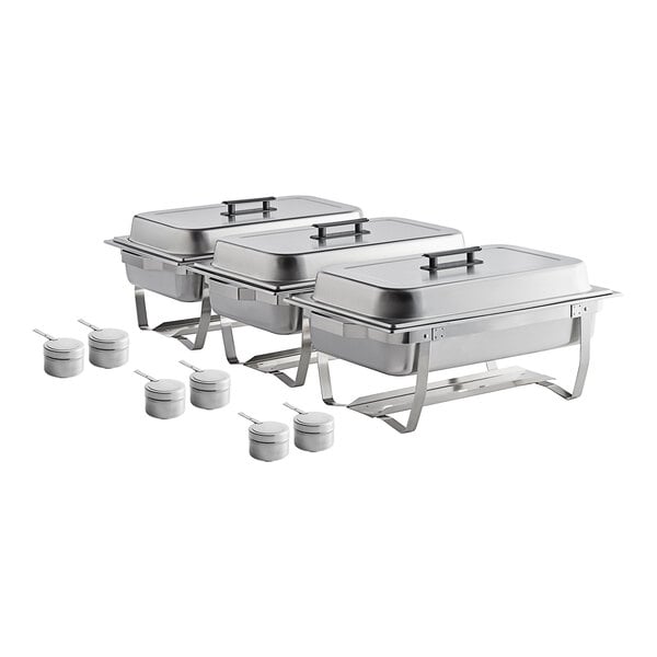 Three stainless steel chafers with lids and spoons on a white surface.