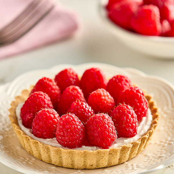 A close up of a bowl of fresh raspberries.