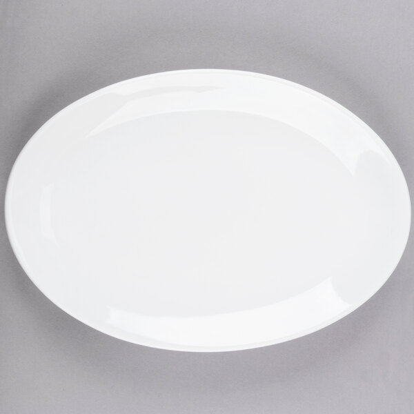 A white oval Libbey Porcelana coupe platter on a gray surface.