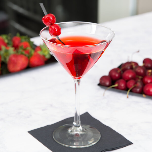 A Libbey Vina martini glass filled with red liquid and cherries on top.