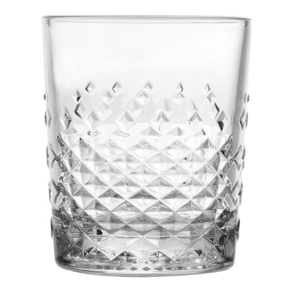 A clear 12 oz. rocks glass with a textured, diamond-patterned lower half.