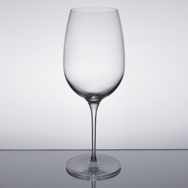 A clear Reserve by Libbey Renaissance wine glass on a reflective surface.