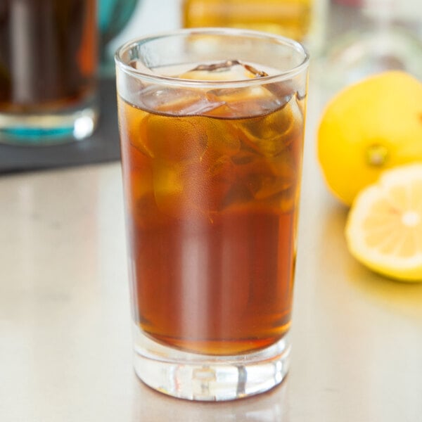 A Libbey highball glass of iced tea with lemon and ice.