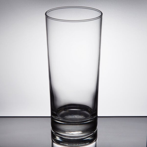A Libbey Heavy Base clear cooler glass on a white table.