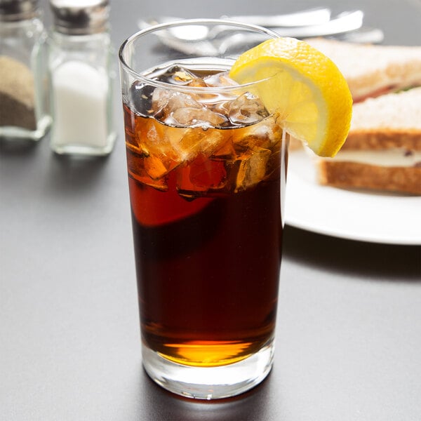 A Libbey Heavy Base Cooler Glass of iced tea with a lemon wedge.