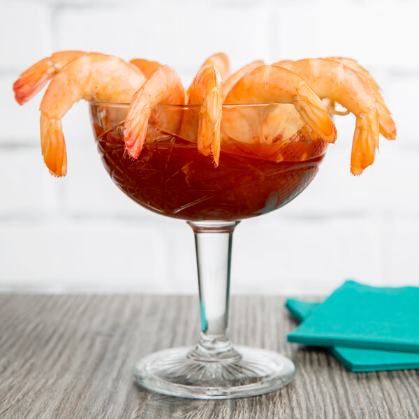 A Libbey coupe cocktail glass with shrimp in it.