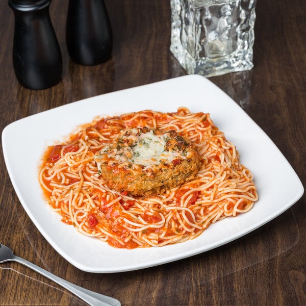 A Libbey Porcelana square coupe plate with spaghetti and meatballs.