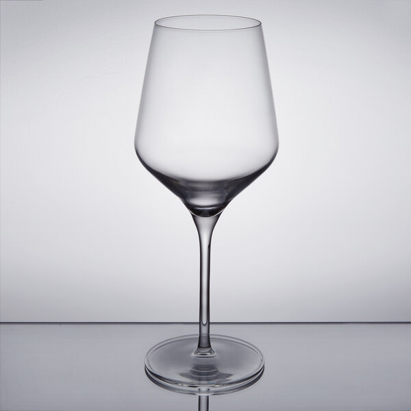 A close-up of a Reserve by Libbey Prism wine glass with a clear surface.