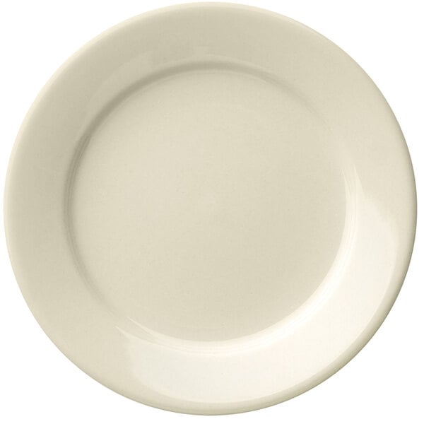 A Libbey Porcelana cream white porcelain plate with a wide rim and rolled edge.