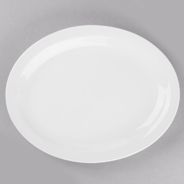 A Libbey Porcelana white porcelain platter with a white rim on a gray surface.