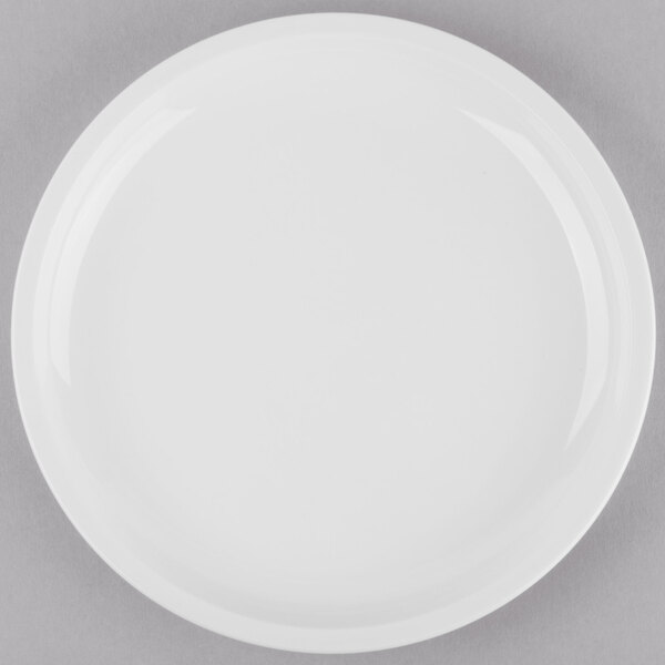 A Libbey Porcelana bright white porcelain plate with a white rim on a gray surface.