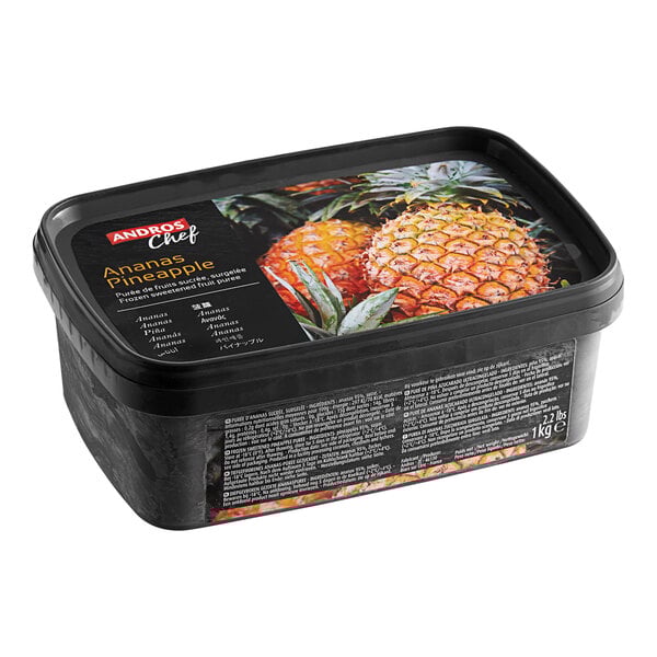 A black rectangular container of Andros Chef Sweetened Pineapple Puree with a picture of pineapples.