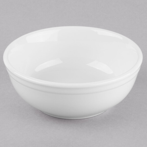 A Libbey Porcelana bright white porcelain oatmeal bowl on a gray surface.