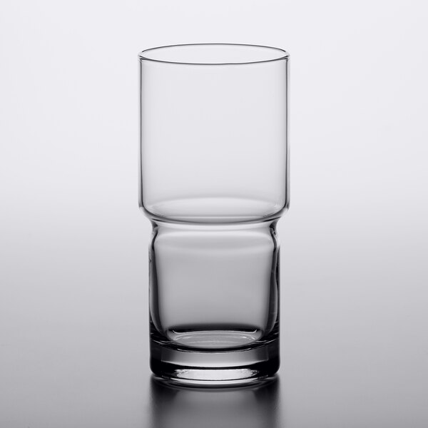 A close-up of a Libbey Newton stackable beverage glass filled halfway with a clear beverage.