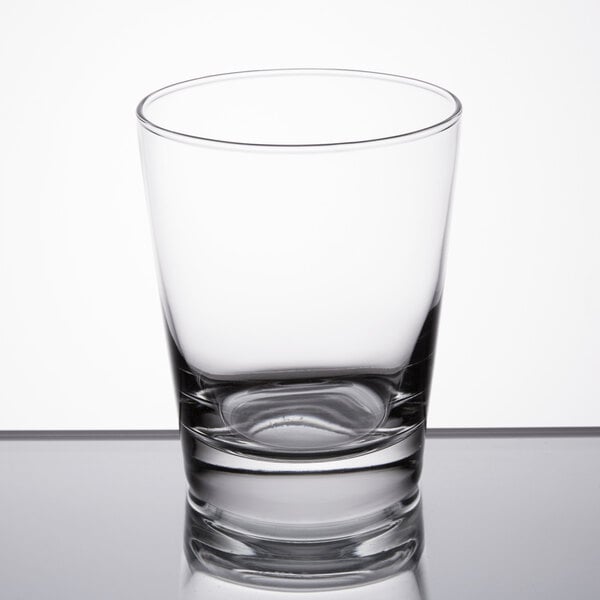 A Libbey double old fashioned glass on a table with a reflection.