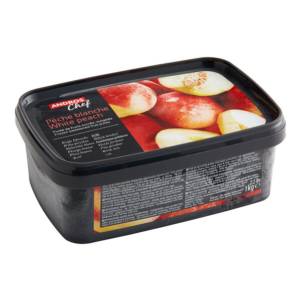 A black container of Andros Chef Sweetened White Peach Puree with a label on it.