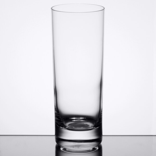 A Reserve by Libbey Modernist beverage glass full of a clear drink with a straw.