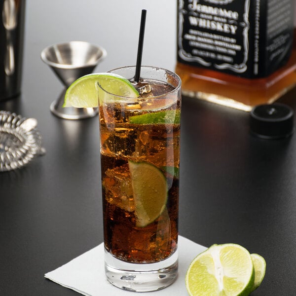 A Reserve by Libbey Modernist beverage glass of ice tea with a lime slice on a napkin.