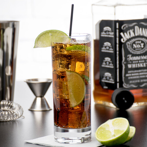 A Reserve by Libbey Modernist beverage glass full of liquid with a lime slice on the rim.