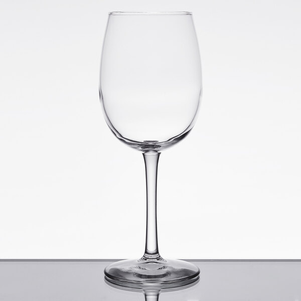 A clear Libbey Vina wine glass with a stem on a table.