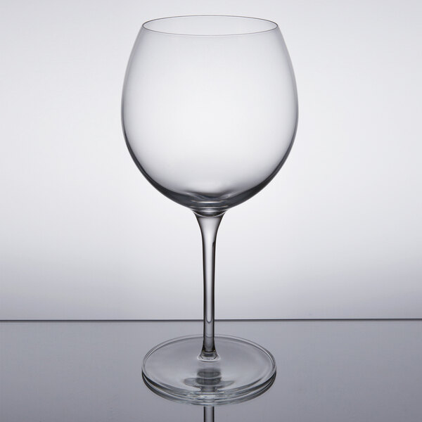 A Reserve by Libbey Renaissance red wine glass on a reflective surface.