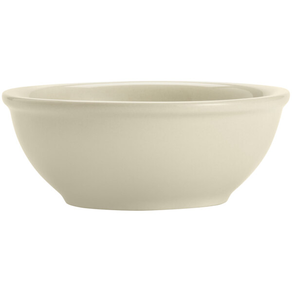 A close-up of a Libbey Porcelana cream white nappie bowl with a rolled edge.