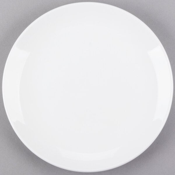 A Libbey Porcelana white porcelain coupe plate on a gray surface.