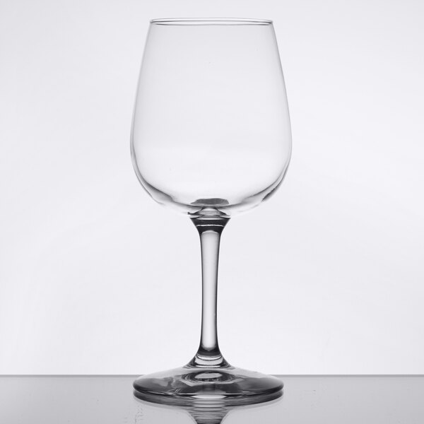 A clear Libbey Vina wine glass on a white table.