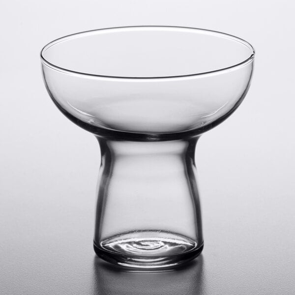 A Libbey clear cocktail glass on a white surface.