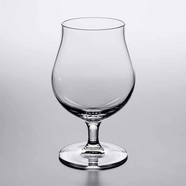 A Reserve by Libbey Belgian beer/tulip glass with a stem on a table.