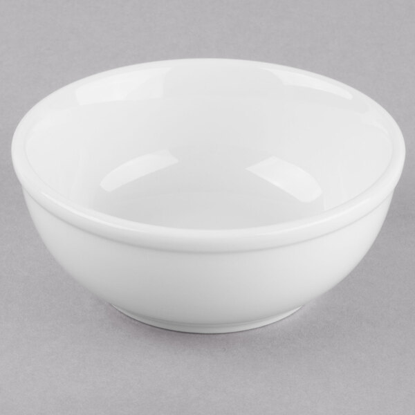 A Libbey Porcelana white porcelain oatmeal bowl on a gray surface.