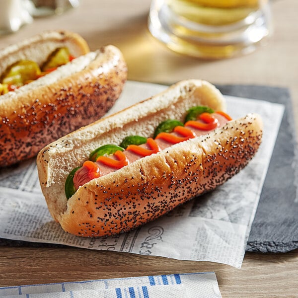 Two Turano poppy seed hot dogs on a table with mustard and ketchup.