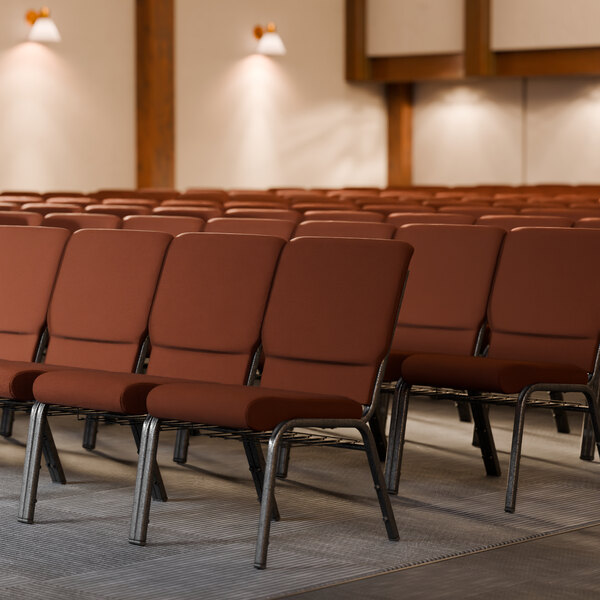 Lancaster Table & Seating silver vein church chairs in a row with brown fabric seats.