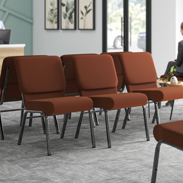 Lancaster Table & Seating silver vein church chairs with brown fabric in a room