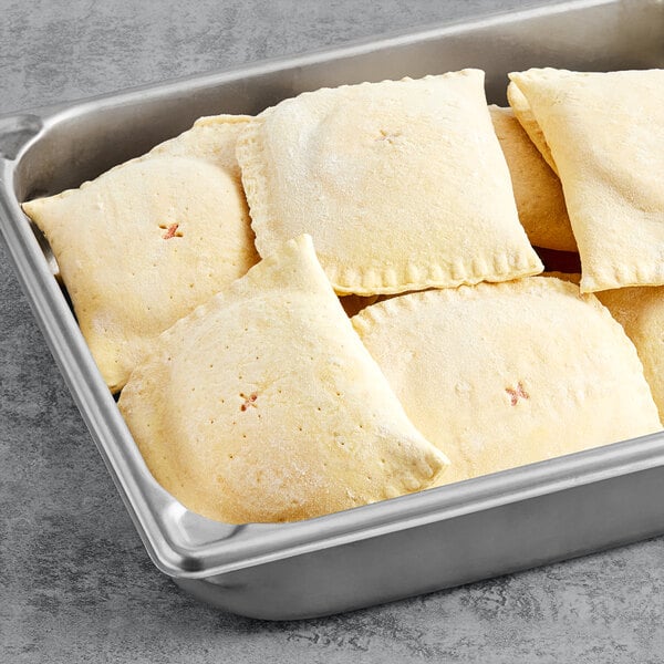 A metal tray filled with unbaked Caribbean Food Delights Plantain Tarts.