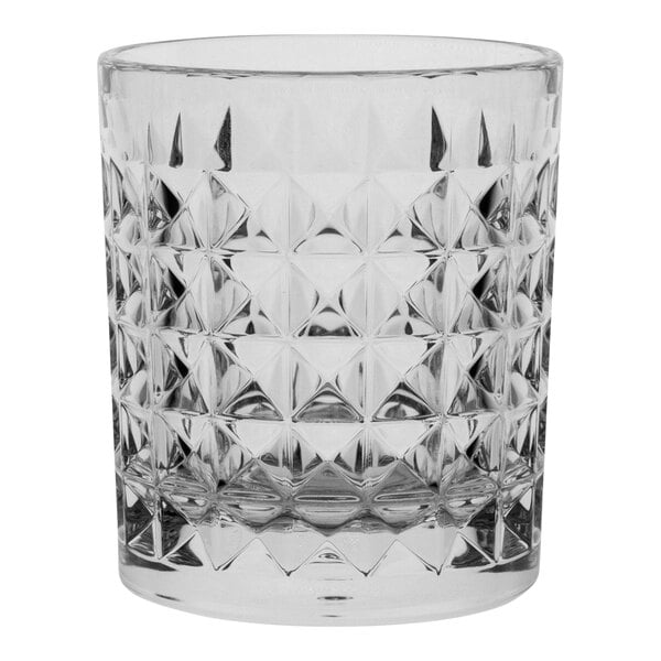 A close up of a clear Aspen Carve glass with a diamond pattern.