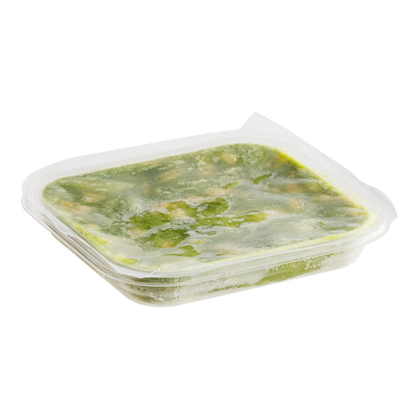 A white plastic tray of Wholly avocado slices and pieces.