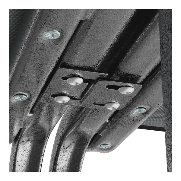 A close-up of a silver metal interlocking bracket for a Lancaster Table & Seating Church Chair.