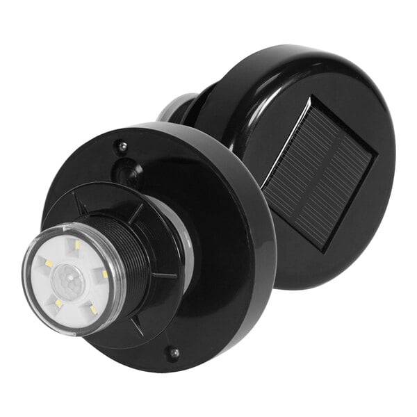 A close-up of a black J & J motion-activated solar light with a solar panel.