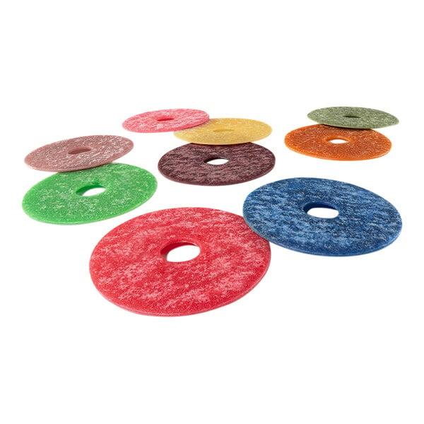 A group of colorful round J-Disk fragrance enhancers with a hole in the center.