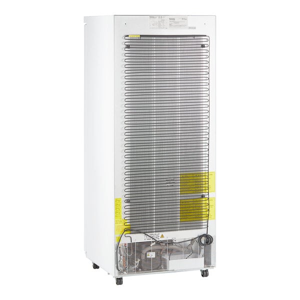 The rear view of a white Galaxy reach-in freezer.