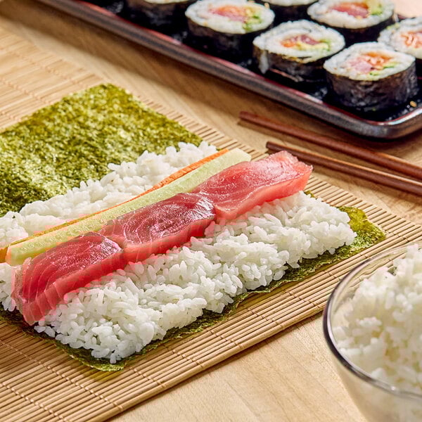 A sushi roll with Calrose Sushi Rice, salmon, and cucumber.