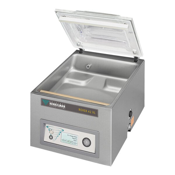 A silver Henkelman vacuum packaging machine with a clear lid.