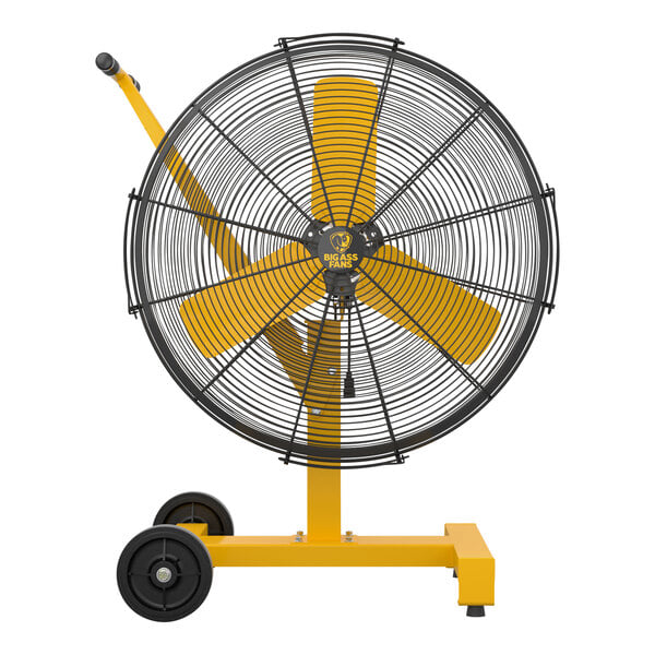 A yellow and black Big Ass Fans AirEye Low Rider pedestal fan with black wheels.