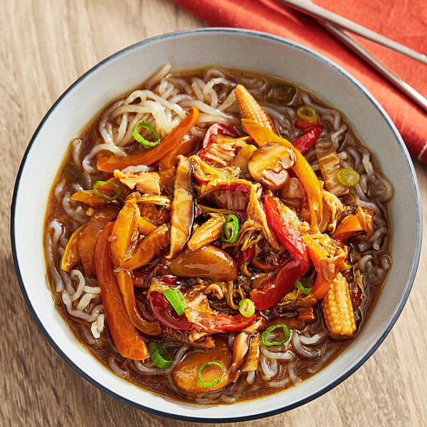 A bowl of noodles with vegetables and Lee Kum Kee Vegan Gluten-Free Oyster Flavored Sauce.