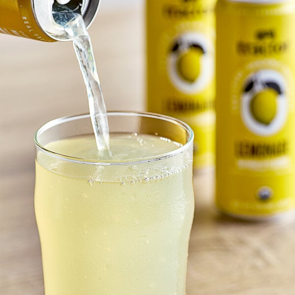 A yellow Tractor Beverage Co. lemonade can pouring into a glass.