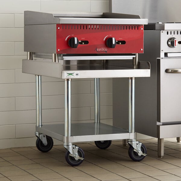 A stainless steel Regency equipment stand with a galvanized undershelf and casters under a stainless steel counter.