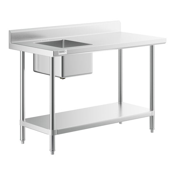 A Regency stainless steel work table with a sink on the left.
