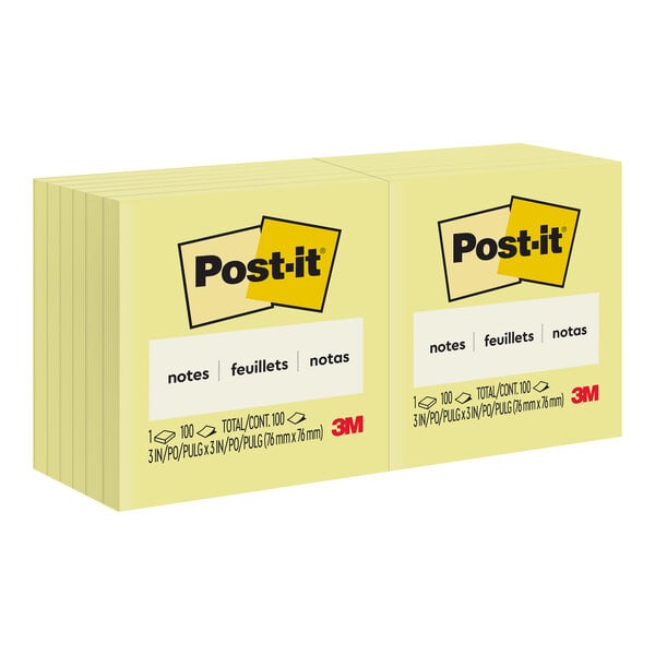 A stack of 3M Post-It yellow sticky note pads.