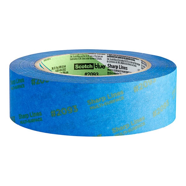 A close-up of a roll of 3M ScotchBlue blue painter's tape with green writing on it.